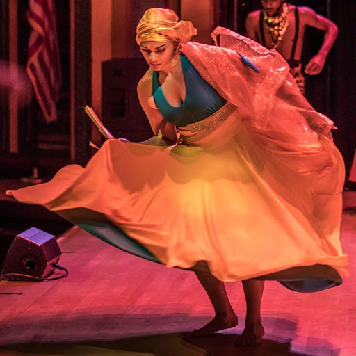 Dancer incorporating traditional Latin clothing into her dance.