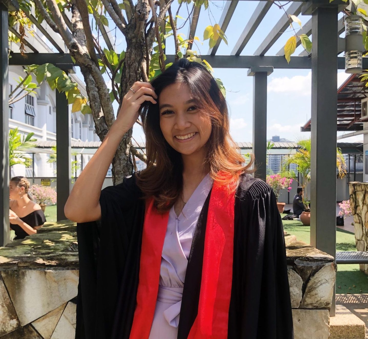 A young woman graduation robes outside