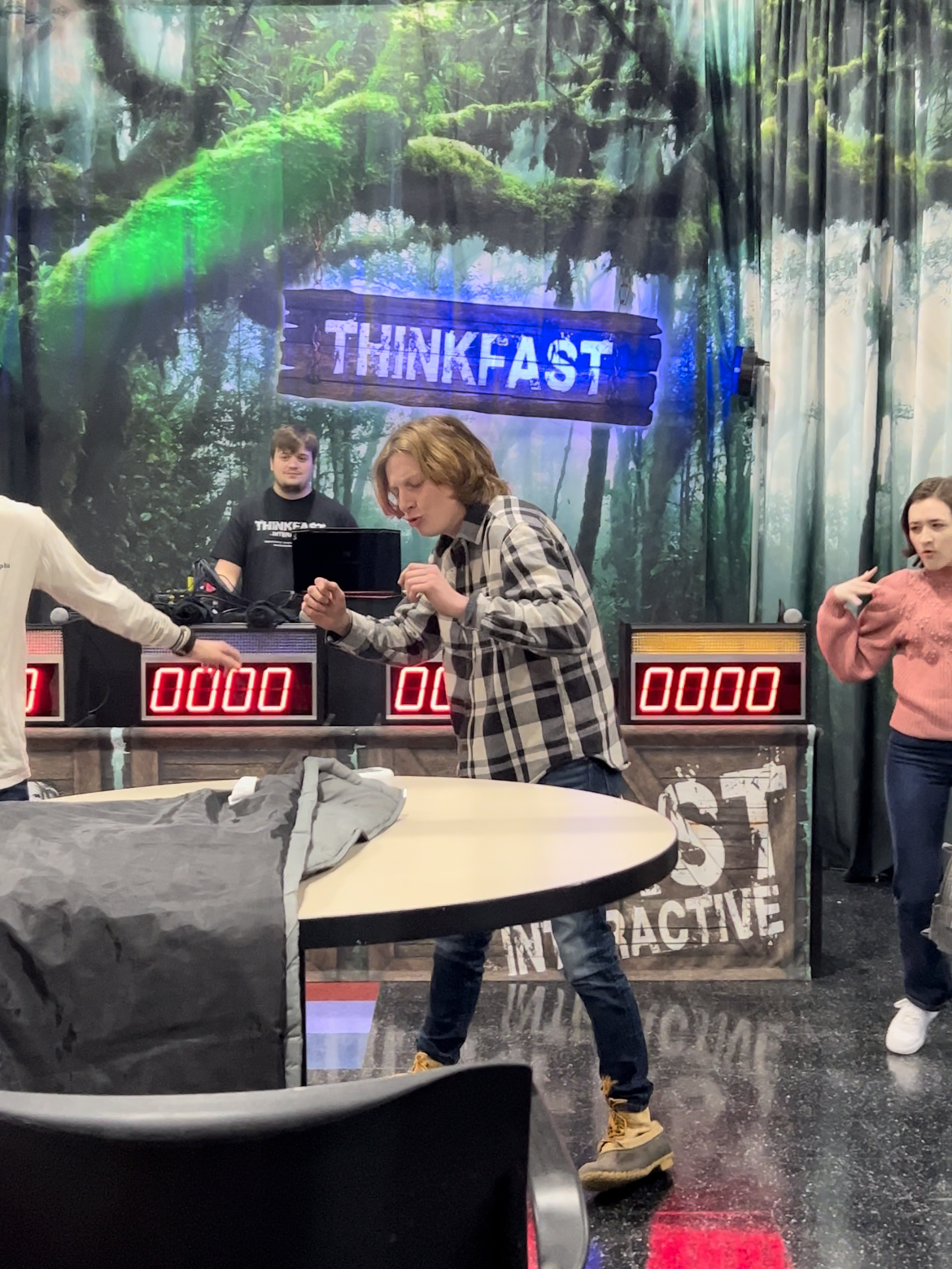 Students dance in front of the ThinkFast backdrop