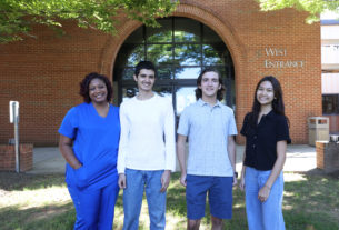 posed group of four students in front of the West Entrance to PVCC's main building
