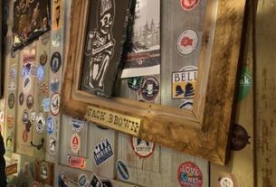 Stickers, frames, paintings, and many more trinkets of all sizes displayed on the wall of Jack Brown's.