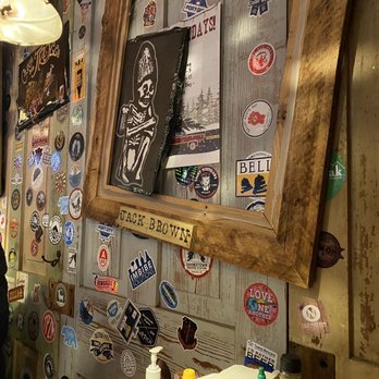 Stickers, frames, paintings, and many more trinkets of all sizes displayed on the wall of Jack Brown's.