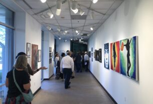 The North Gallery of the Dickenson Building with guests and artists attending the reception.