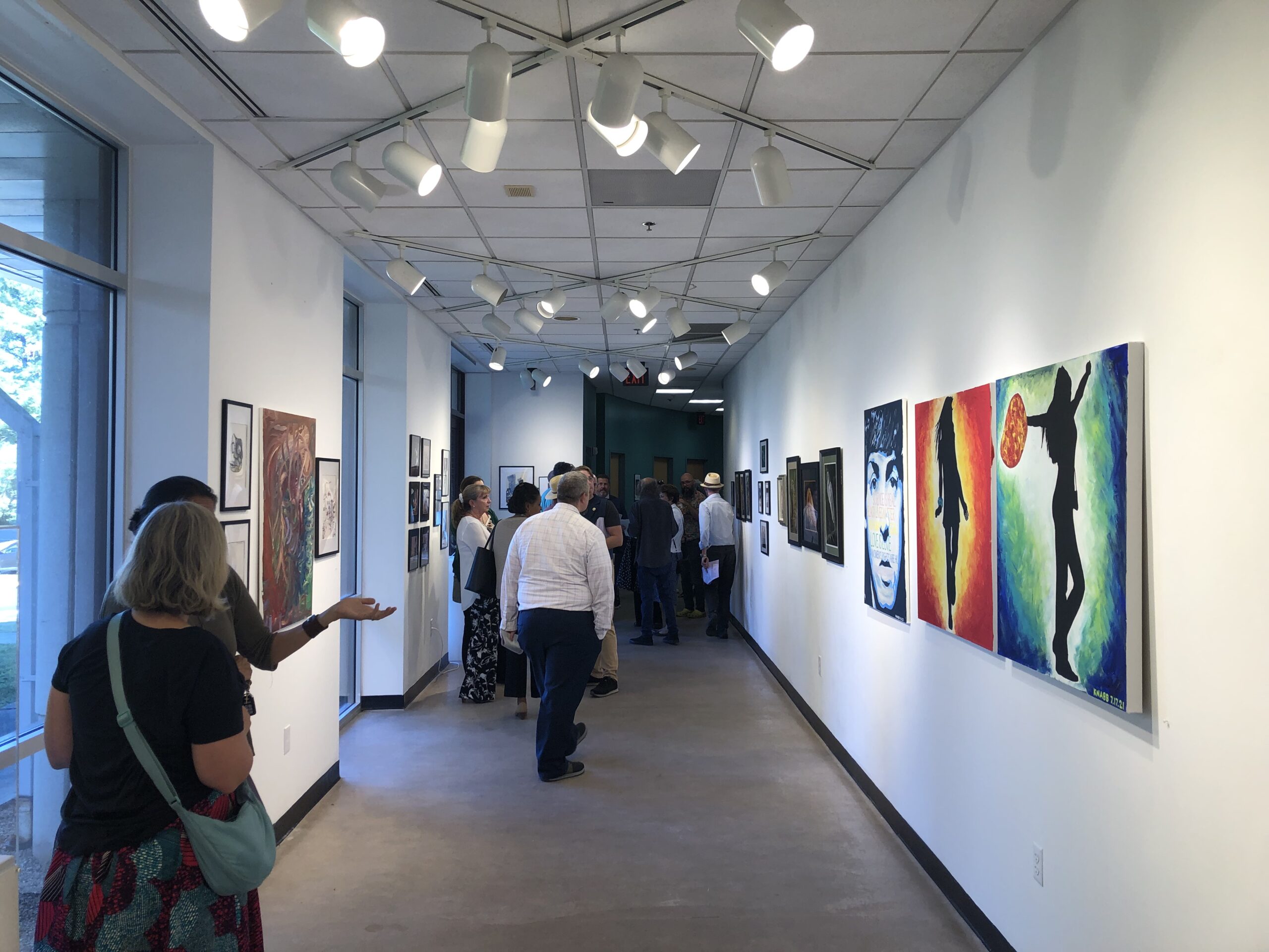 The North Gallery of the Dickenson Building with guests and artists attending the reception.