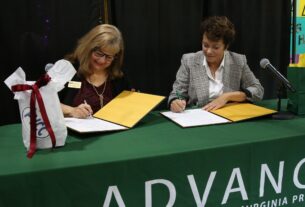 Dr. Muir and Dr. Runyon signing the ADVANCE program
