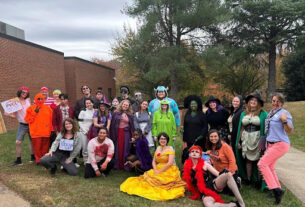 Dressed in a variety of costumes, PVCC students, faculty, and staff gather behind the main building for a group photo.