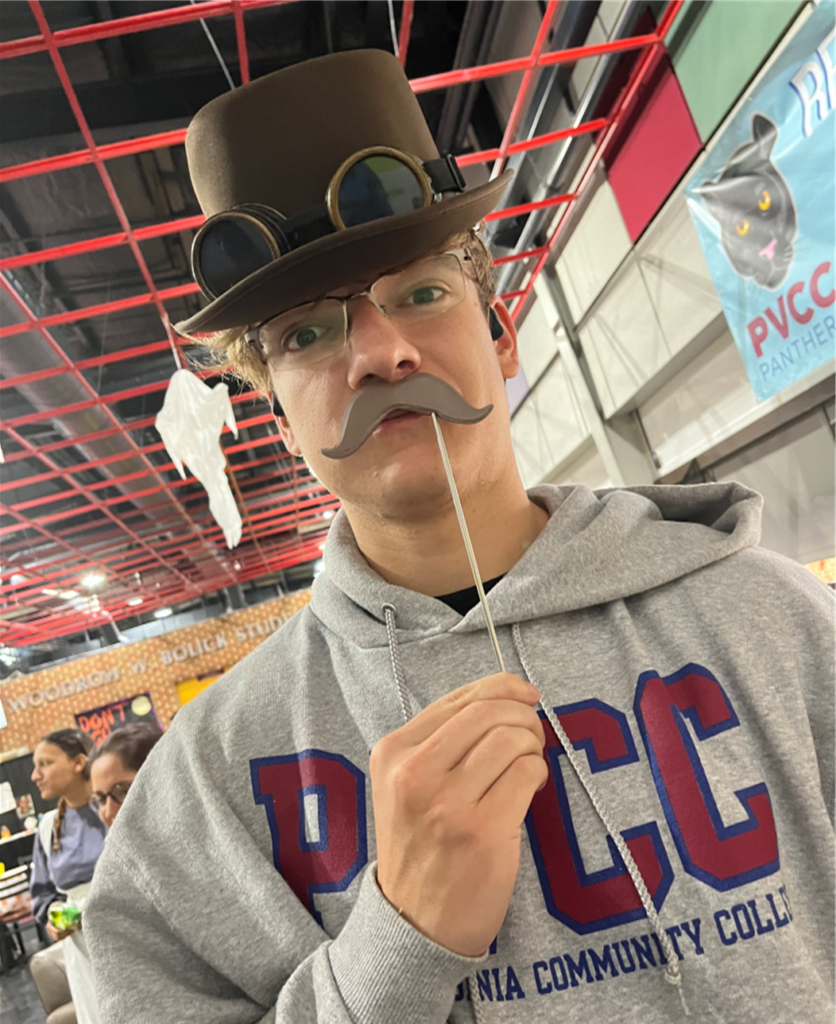 PVCC student Jacob Fitzgerald dressed in a steampunk hat and fake mustash.