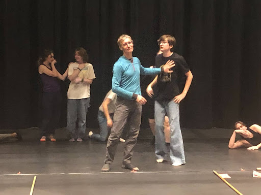 The cast practices choreography for the song "Sweet Transvestite."