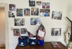 a wall of pictures with blue buckets containing American flags in front of them