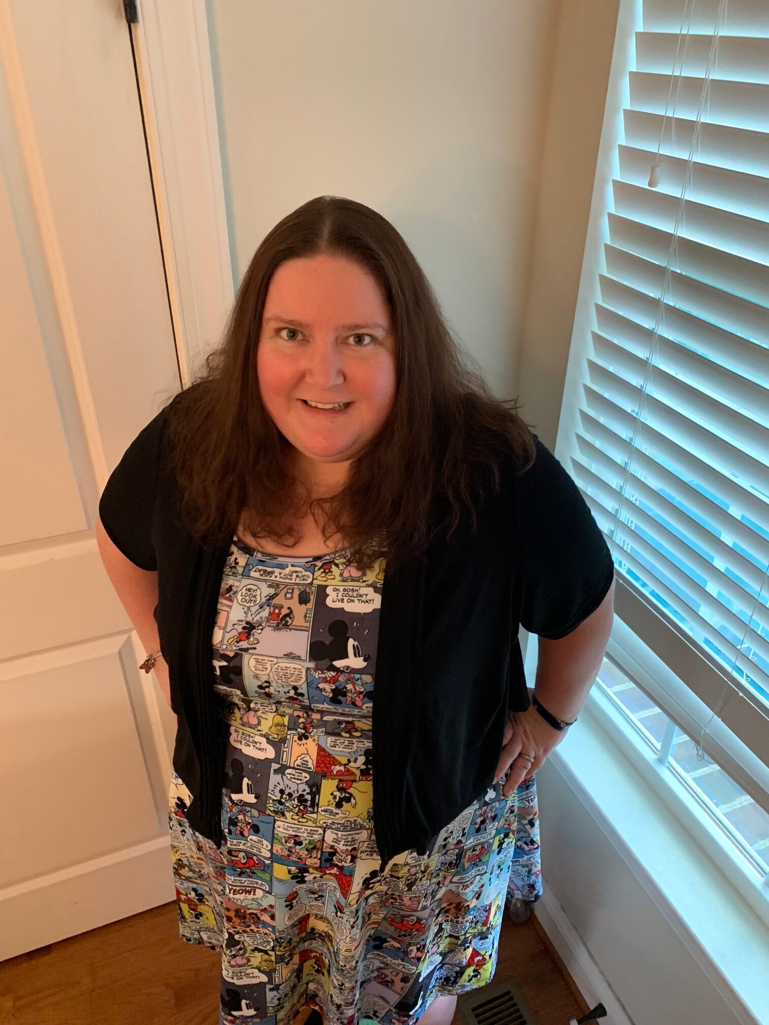 A photograph of Dr. Tamara Whyte wearing a dress decorated with Mickey Mouse comic strips.