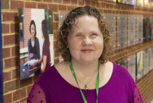 Sandra Bullins standing in a hallway of the main building.