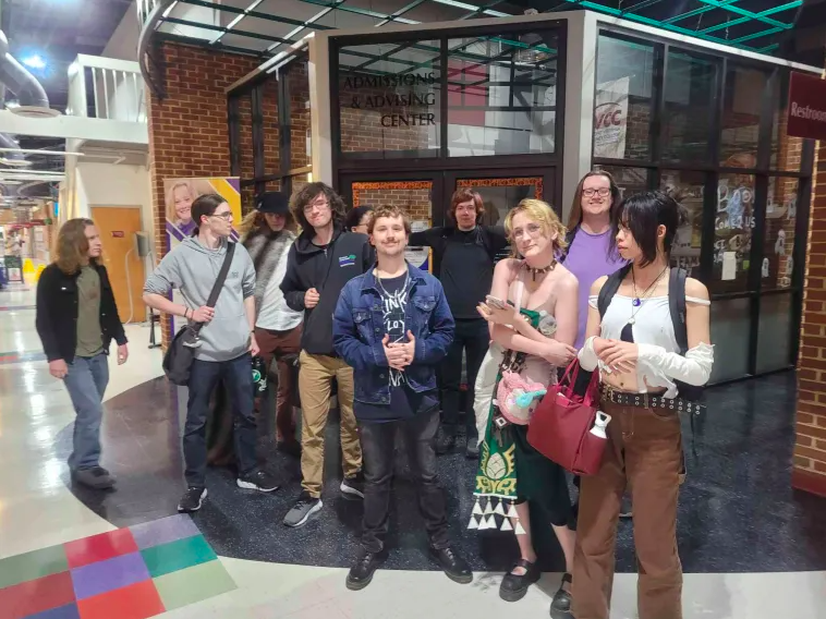 Members of the D&D Club, some in Halloween costumes, pose for a photo in front of the North Mall Meeting Room.