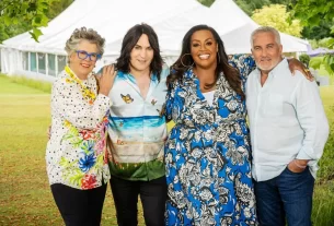 Four cast members of Great British Bake Off stand together outside of the tent.