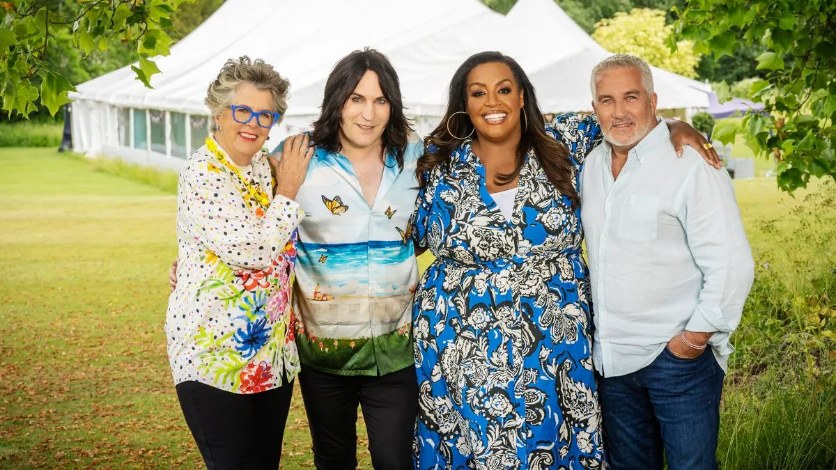 Four cast members of Great British Bake Off stand together outside of the tent.