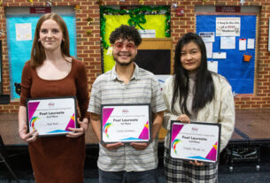 The three winners of the Poet Laureate standing in front of a stage.