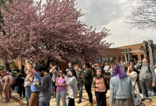 The crowd of PVCC students stood looking up at the eclipse on the outdoor patio