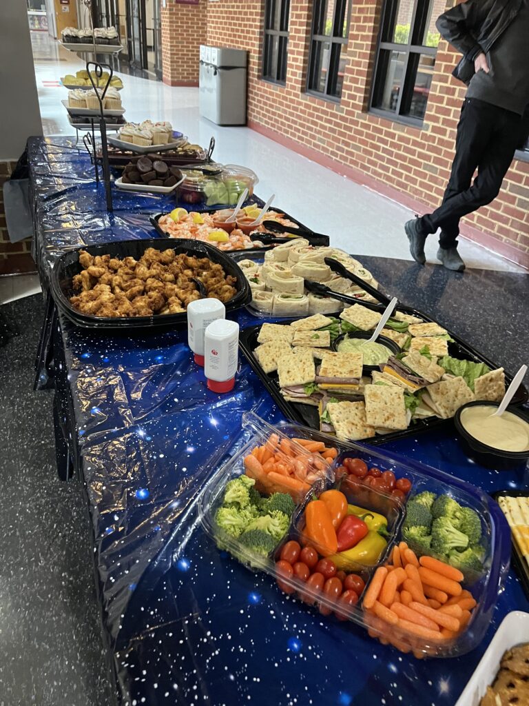 Various food including Chick-Fil-A sitting on a buffet table