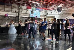 A group of students dance in an open space.