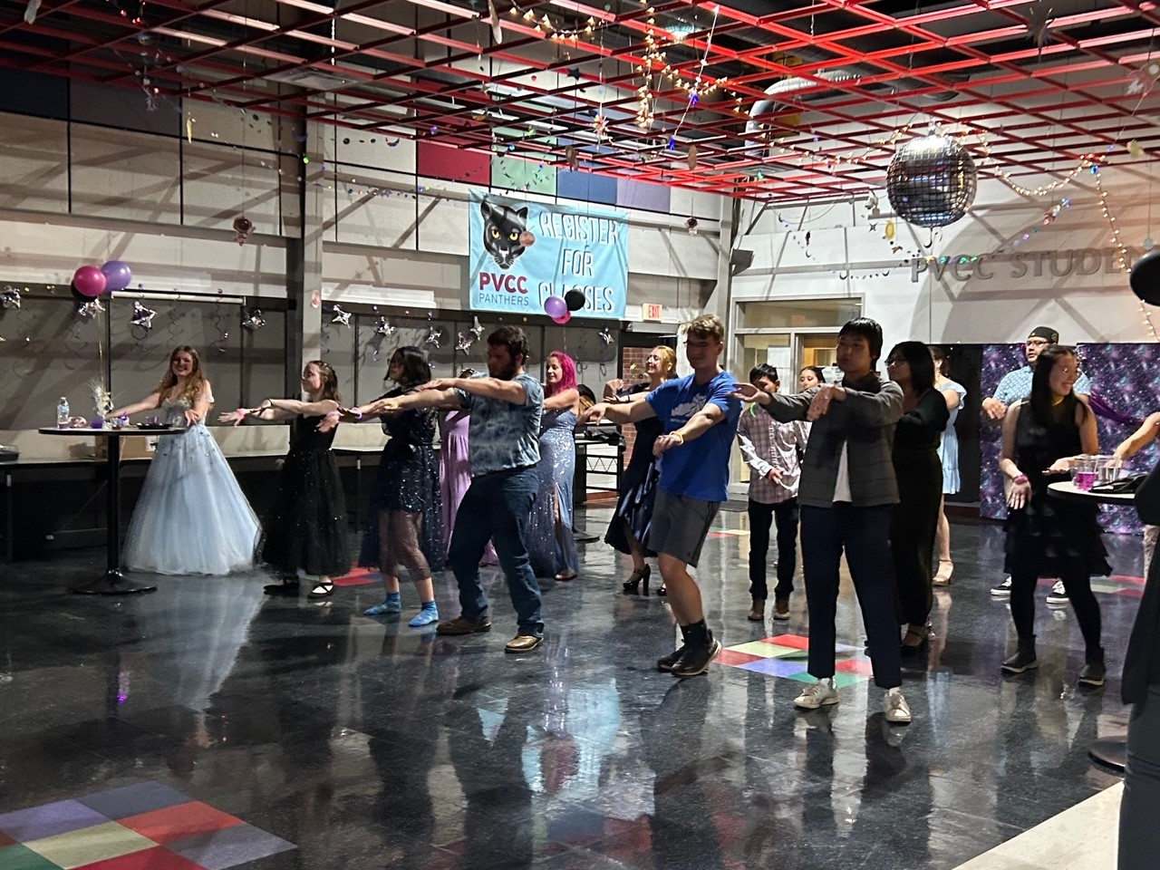 A group of students dance in an open space.