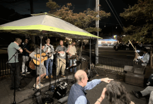 The Bluegrass Destroyers band performing under a tent on the patio at Bar Banelo