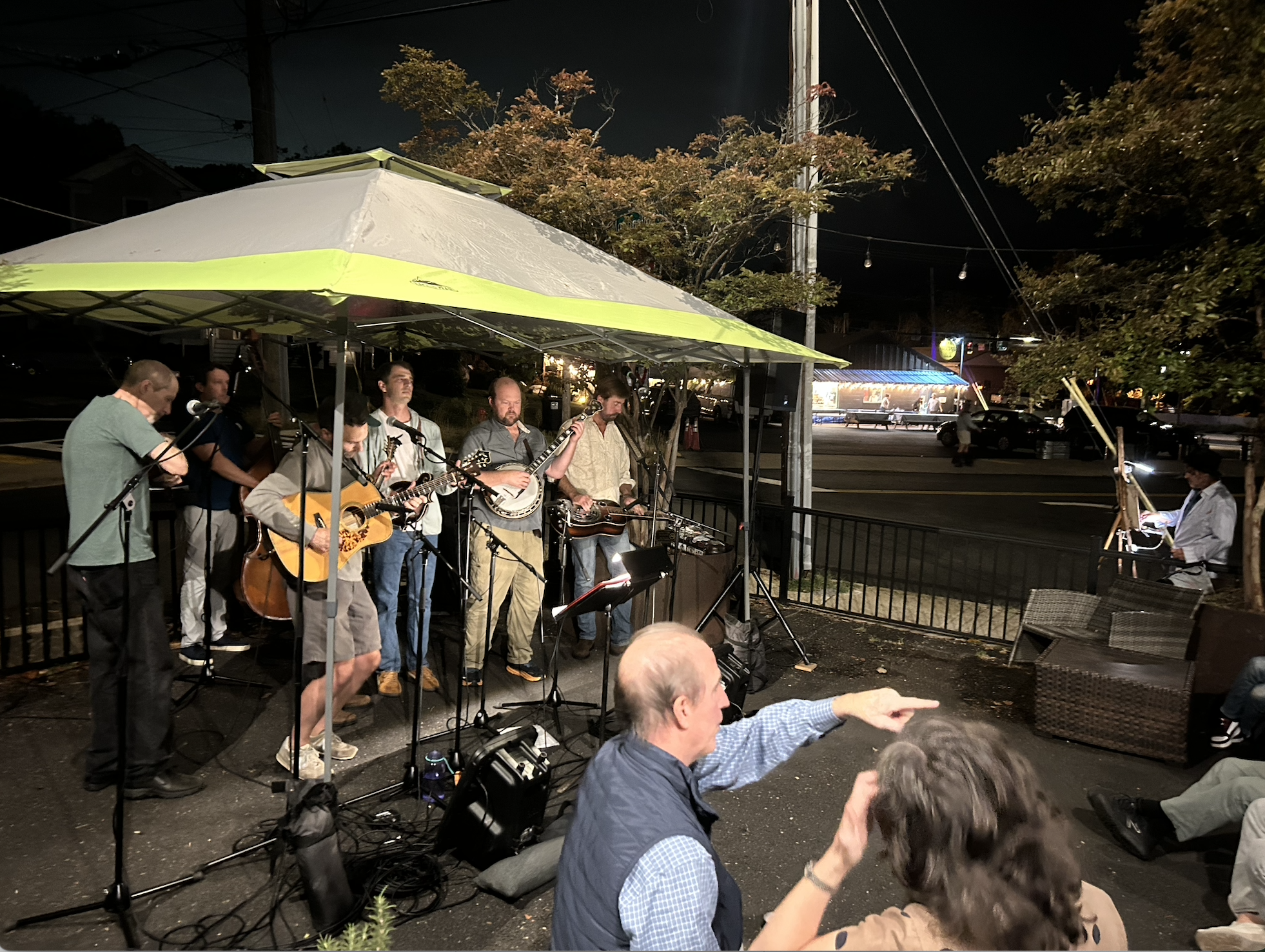 The Bluegrass Destroyers band performing under a tent on the patio at Bar Banelo