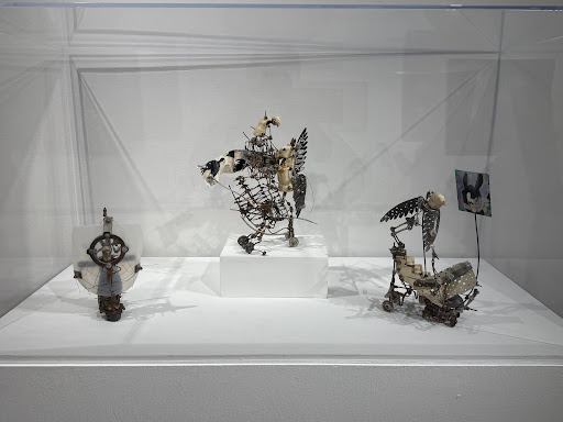 Aggie Zed’s sculptures: three small metal sculptures in a case.
