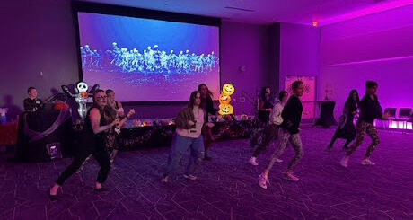 Thriller Flash Mob participants dance like zombies in a purple room