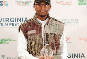 Miles Canton posing with his “Achievement in Film Music” Award.