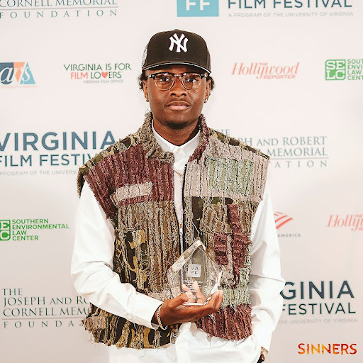Miles Canton posing with his “Achievement in Film Music” Award.