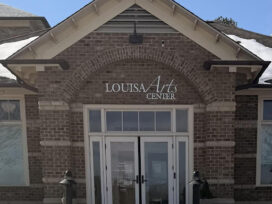 A front-facing view of the Louisa Arts Center building entrance on a snowy day.