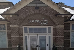 A front-facing view of the Louisa Arts Center building entrance on a snowy day.