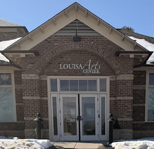 A front-facing view of the Louisa Arts Center building entrance on a snowy day.