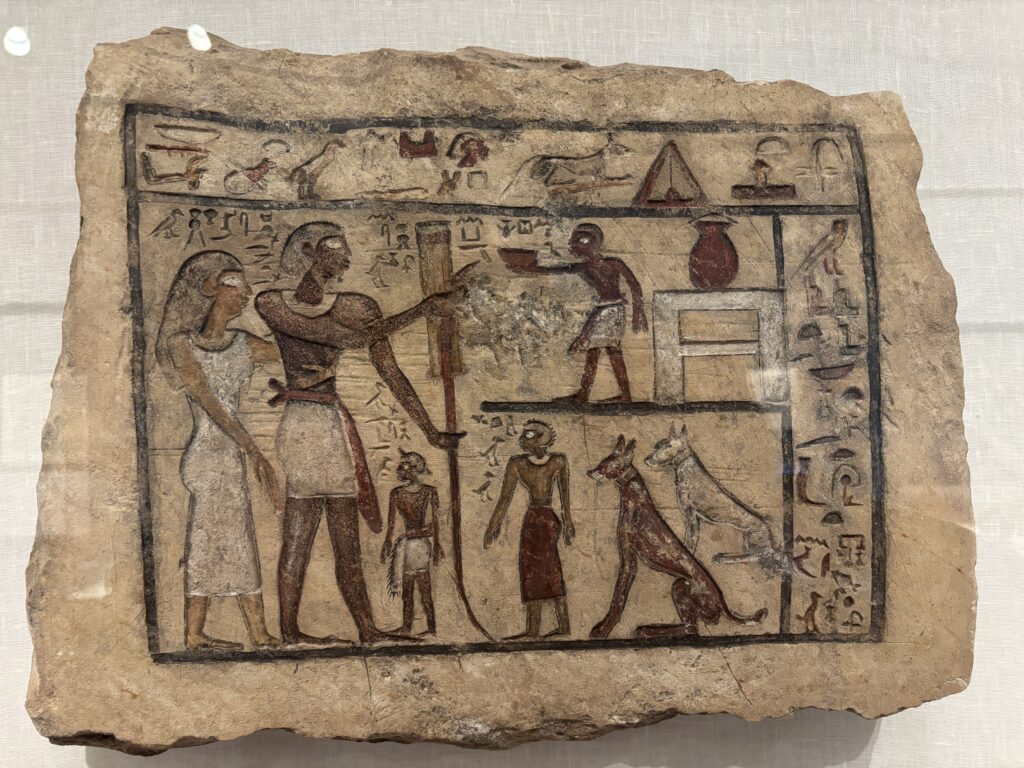 An Egyptian funerary image depicting a man, his wife, their two children, a servant, and a dog.