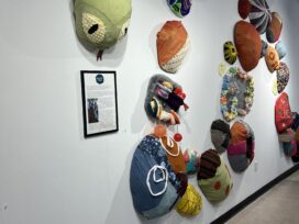 Circles in the shape of a snake made of various fabrics, some of which feature activities.