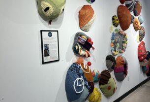 Circles in the shape of a snake made of various fabrics, some of which feature activities.