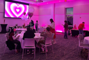 tables with students with a pink room with a heart on the wall