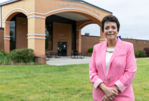 President Dr. Jean Runyon standing in front of PVCC.