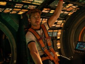 Ryan Gosling as his character Ryland Grace sitting in the pilot seat of the ship, The Hail Mary.