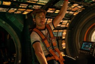 Ryan Gosling as his character Ryland Grace sitting in the pilot seat of the ship, The Hail Mary.